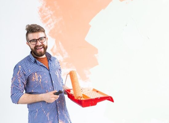 happy man painting interior wall with paint roller new house guy with roller applying paint 230311 12112.jpg happy man painting interior wall with paint roller new house guy with roller applying paint 230311 12112.jpg